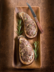 stuffed eggplants on wood dish