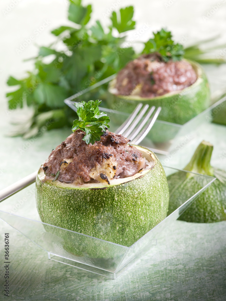 Wall mural stuffed zucchinis on glass over green backgrond