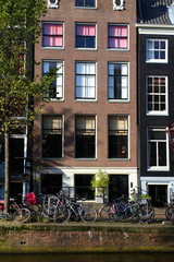 Fototapeta na wymiar Typical Amsterdam houses over blue sky