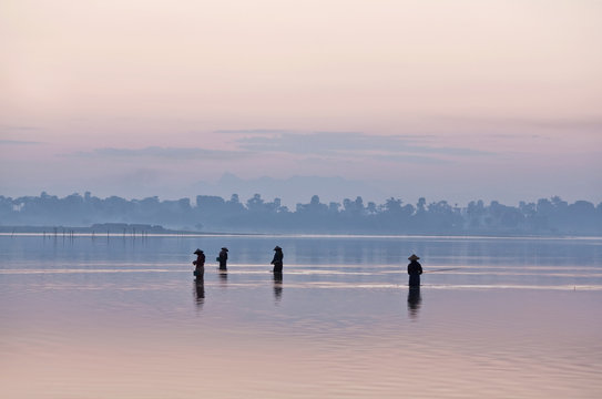 Silhouettes of women in fishing on the lake, Myanmar