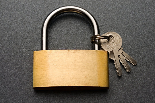 Lock with keys on the grey background