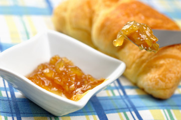 Orange jam and croissant