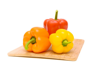 peppers of different colors on a cutting board