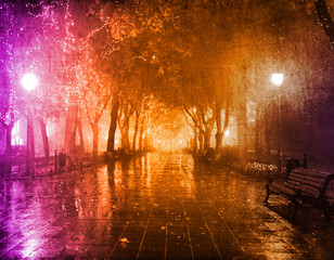 Bench in night alley with lights in Odessa, Ukraine.