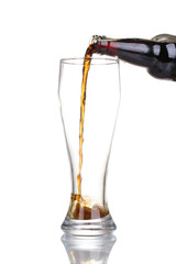 dark beer poured into a glass isolated on white