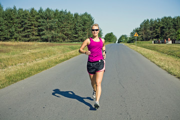 Woman runner on country road
