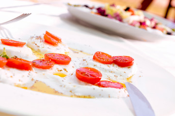 caprese salad in a outdoor restaurant table
