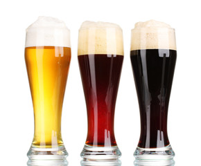 three glasses with different beers isolated on white