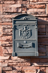 Beautiful mailbox on a brick wall, a summer day