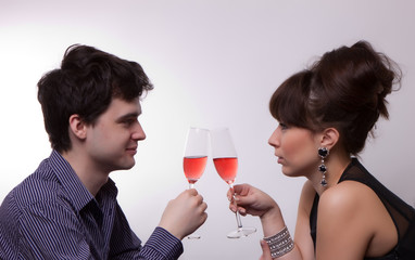 photo of young couple drinking rose wine