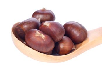 chestnuts in wooden spoon on white background