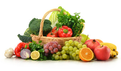 Composition with vegetables and fruits in wicker basket isolated