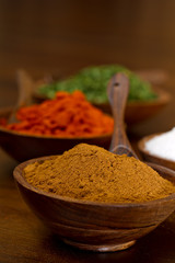 Bowls filled with Spices.  Cumin, Paprika, Salt and Parsley flak