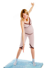 Fototapeta premium pregnant woman on a light background doing exercises