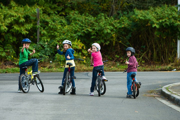 Group of kids looking back on their bikes
