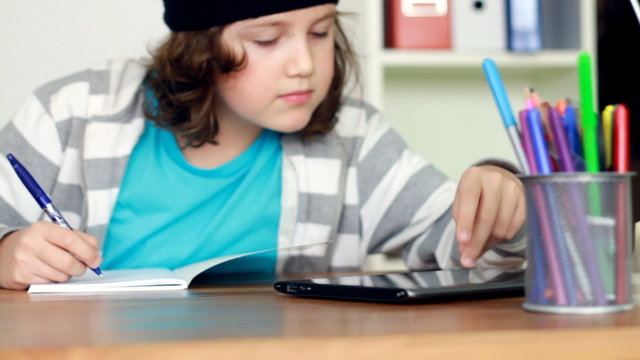 Boy doing homework using tablet computer, steadicam shot