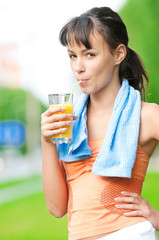 Girl drinking juice after exercise