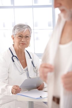 Senior female doctor looking at patient