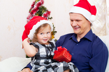 Merry Christmas - little girl with  father with Christmas gifts