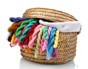 bright threads for needlework and fabric in a wicker basket