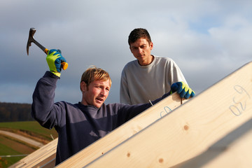 carpenters setting up a roof framework