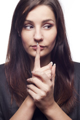Naklejka premium Pretty young businesswoman saying shh