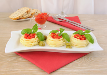 Nest of spaghetti with tomato dressing