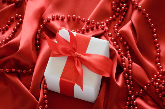 gift box over red silk background