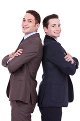 back to back businessmen smiling