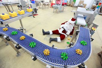 tired overworked santa claus in factory