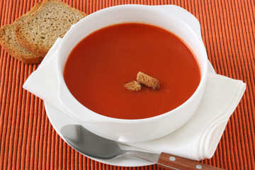 tomato soup in white bowl with toasts
