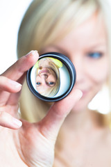 woman showing the principle of imaging through a lens