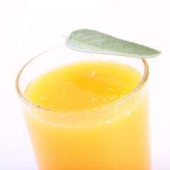 Orange juice, a glass decorated with salvia