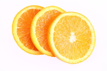 Half an Orange cut into slices on a white background