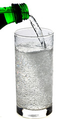 Fizzy drink poured into a glass isolated on white background