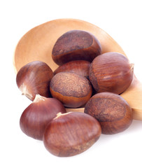 chestnuts in wooden spoon on white background