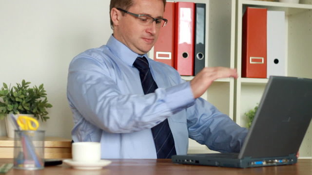 Angry businessman hitting and throw away laptop, slow motion