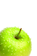 Delicious green apple with water drops