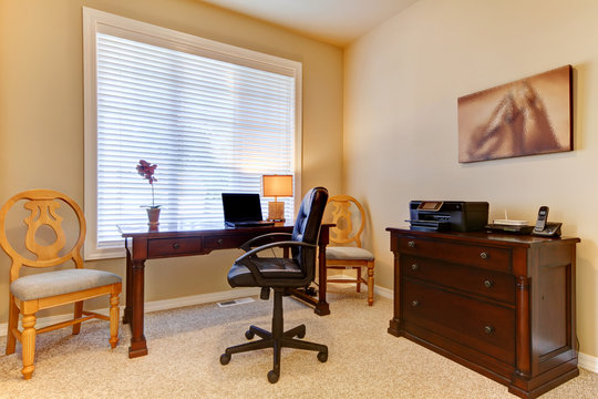 Home office with desk in beige colors