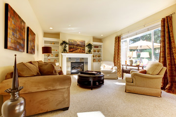 Living room with art, large window, sofas and fireplace.