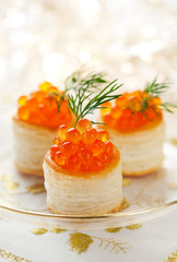 Vol-au-vents filled with red caviar and dill for holiday