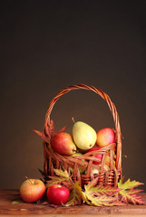 beautiful autumn harvest in basket and leaves