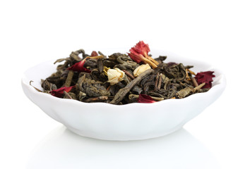 Green dry jasmin tea leaves in plate isolated on white