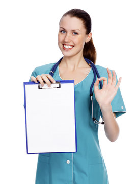 Smiling female doctor holding a clipboard against white backgrou