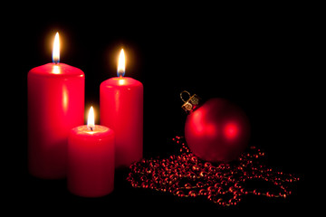 Set of three red candles with string and christmas ball