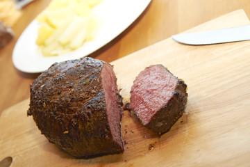 Sliced roastbeef on wooden plank
