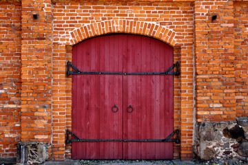 Red door in red brick wall