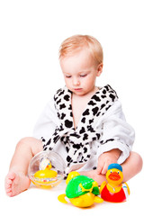 baby boy playing with  toys after bathing