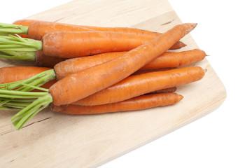 fresh carrots on cutting board