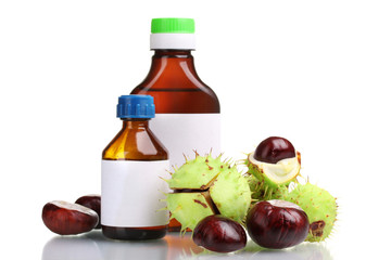 green and brown chestnuts and medical bottles isolated on white